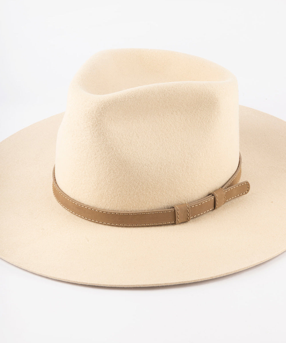 Beige felt fedora hat with a leather band in a white background #color_tan