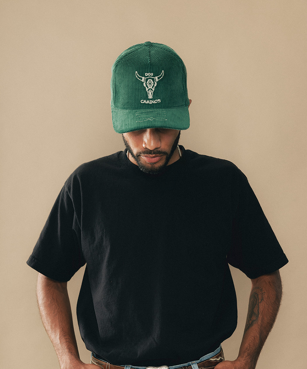 Man wearing a trucker hat in a beige background #color_saguaro