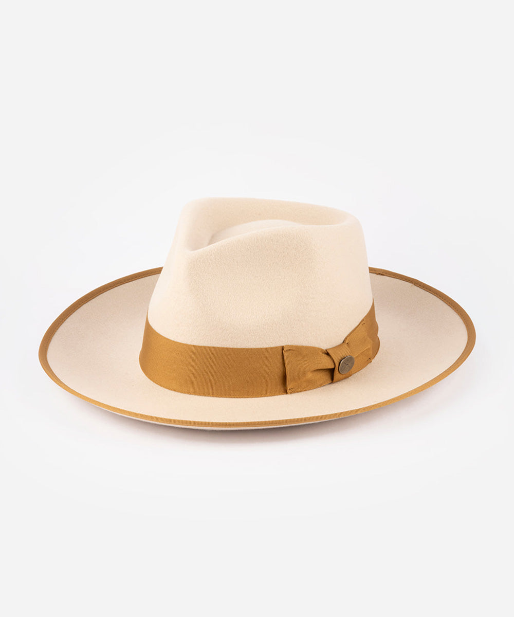 Beige fedora hat with a brown band on a white background #color_buckskin