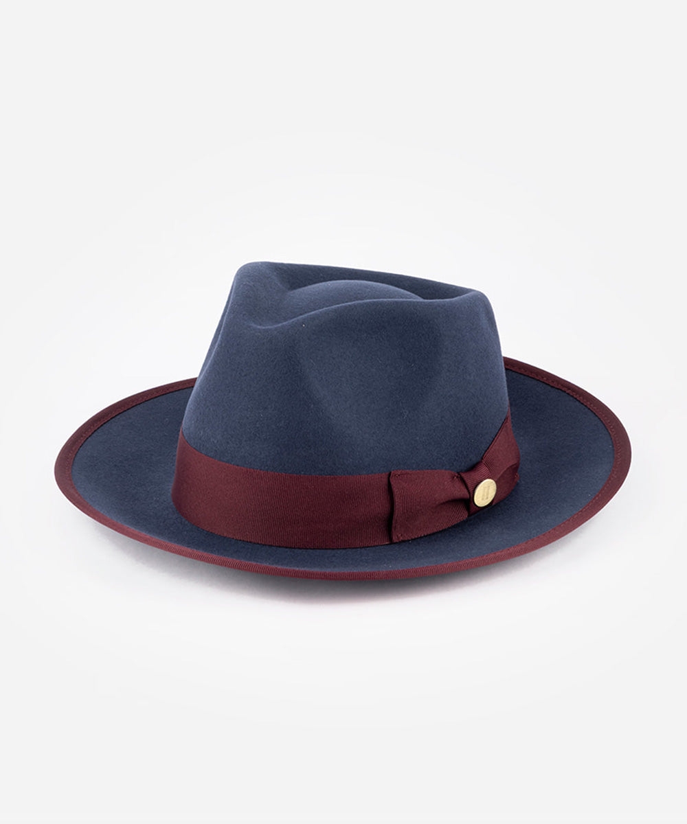 Blue fedora hat with a burgundy band and gold buckle on a white background #color_navy