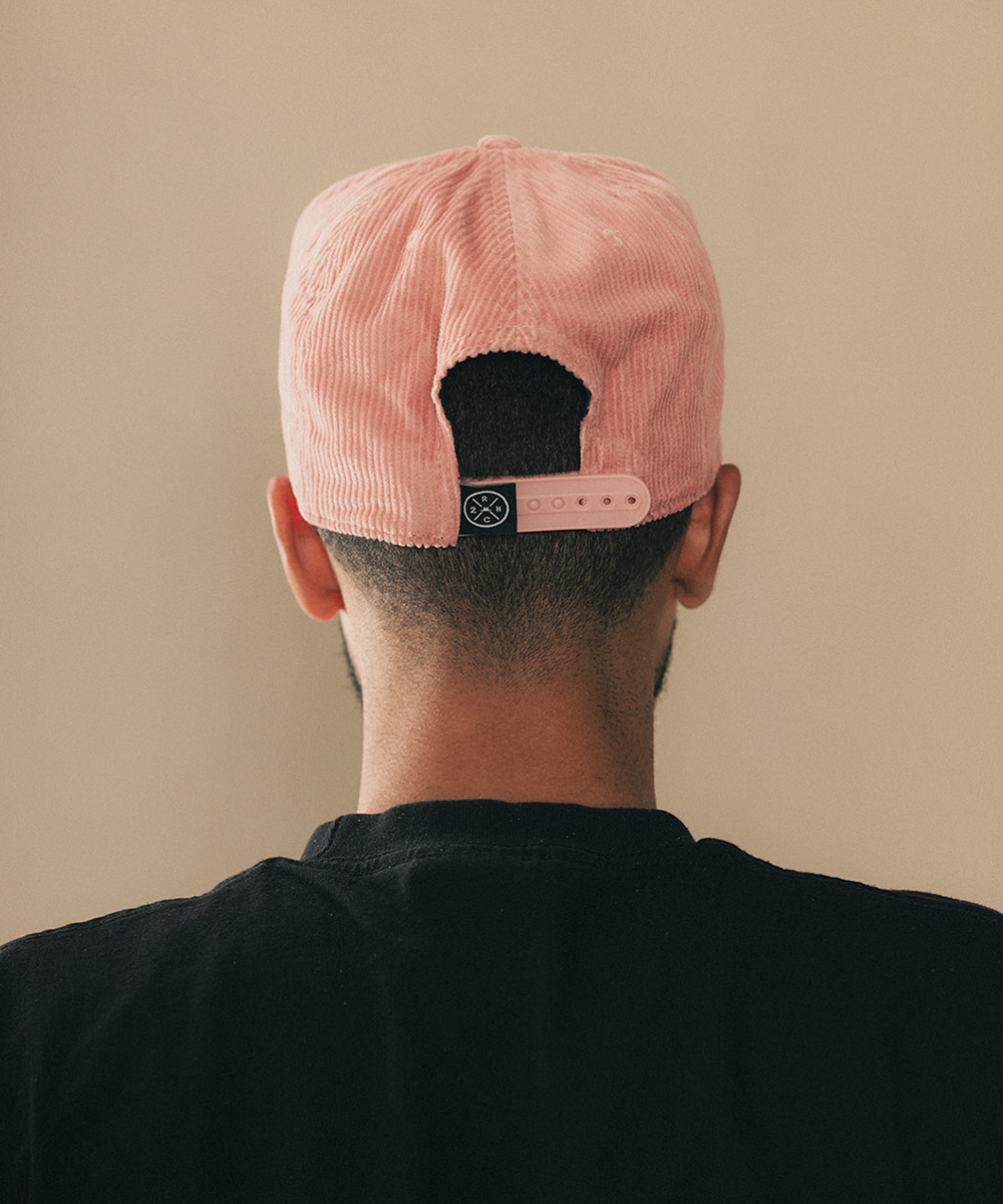 Man wearing a trucker hat in a beige background #color_desert rose