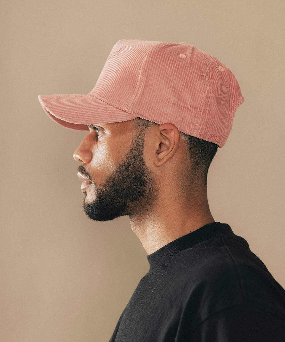 Man wearing a trucker hat in a beige background #color_desert rose