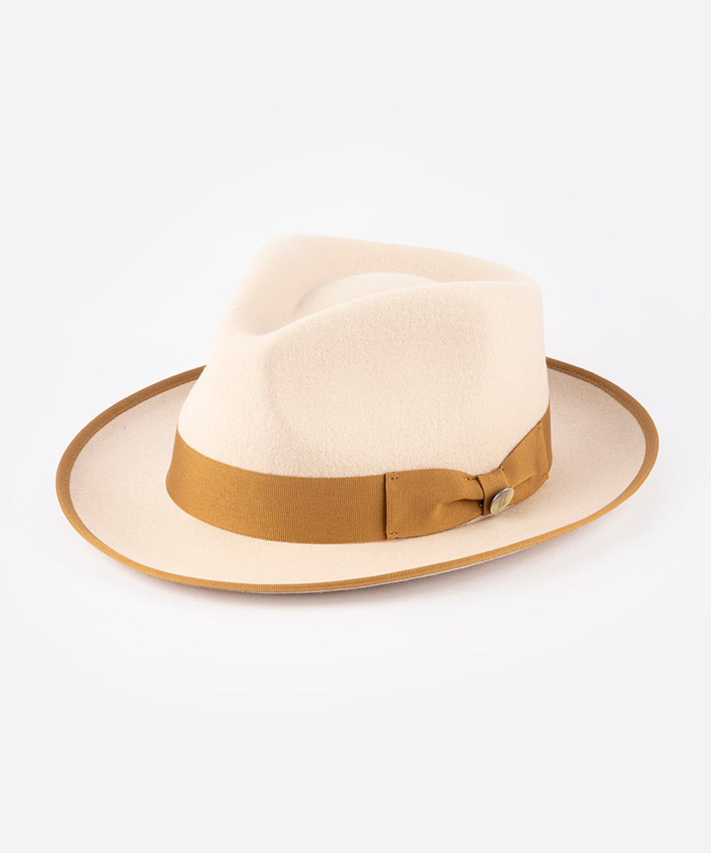 Beige fedora hat with a brown band on a white background #color_buckskin