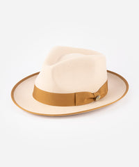 Beige fedora hat with a brown band on a white background #color_buckskin