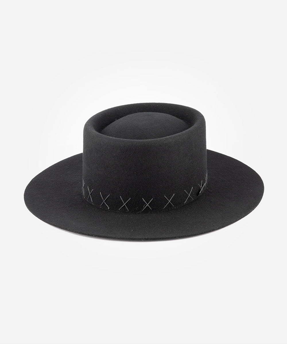 Black gaucho hat with decorative stitching on a light gray background #color_black