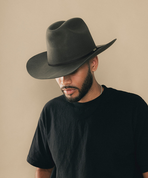 Man wearing a cowboy hat with a beige background #color_hickory