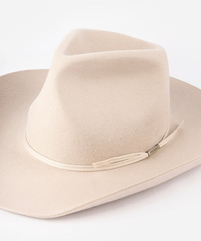 Beige cowboy hat with a band in a white background #color_ivory