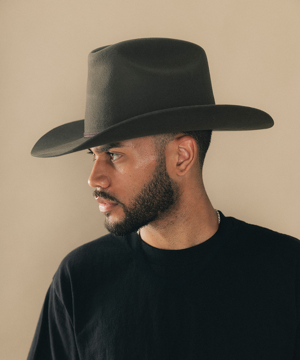 Man wearing a cowboy hat with a beige background #color_hickory