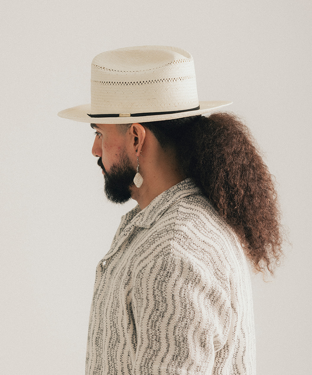 White straw hat with a black band on a white background #color_off white